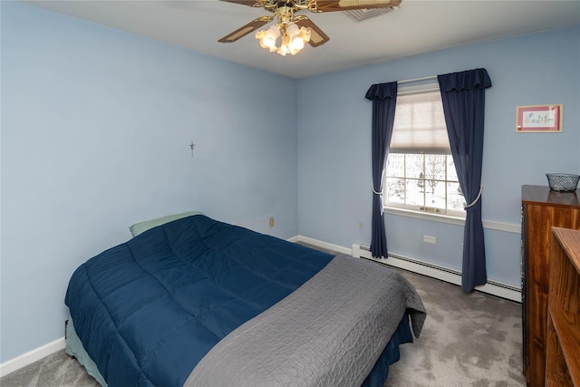 carpeted bedroom featuring a baseboard heating unit and ceiling fan