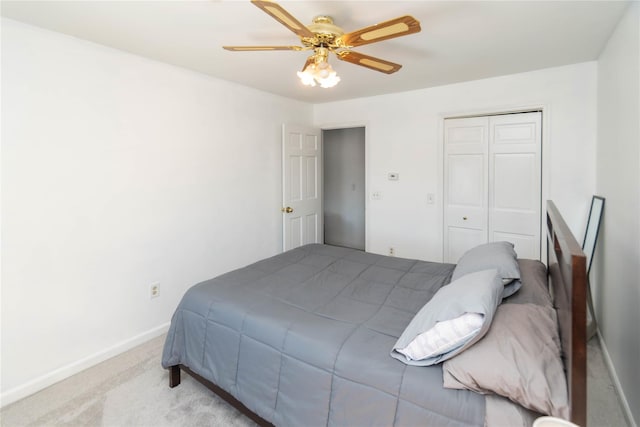 carpeted bedroom featuring ceiling fan and a closet