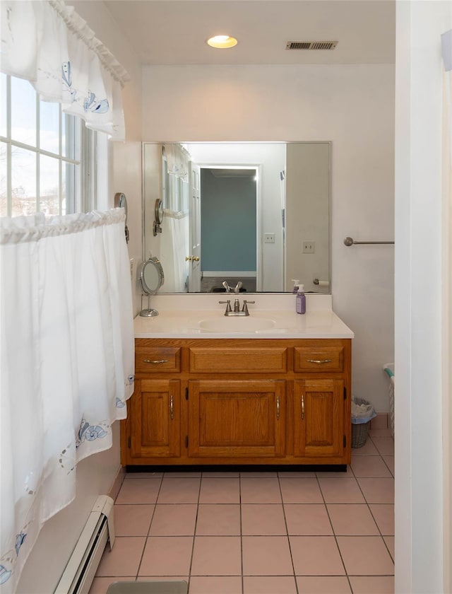 bathroom with tile patterned flooring, vanity, and baseboard heating