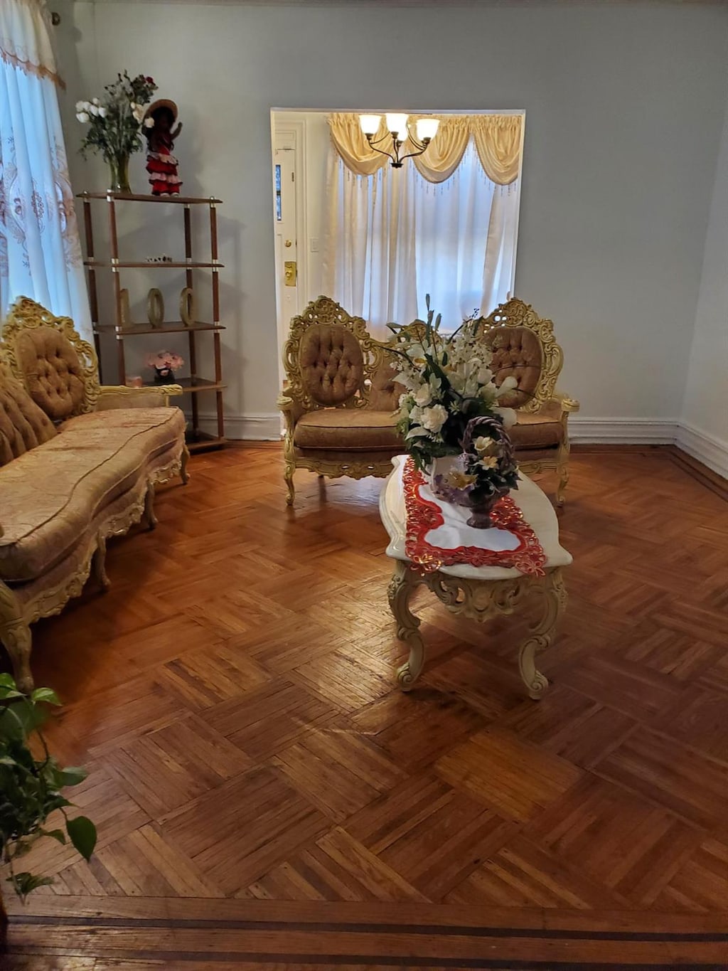 living room with an inviting chandelier and parquet flooring