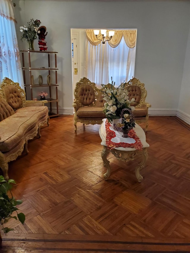 living room featuring parquet flooring and a chandelier