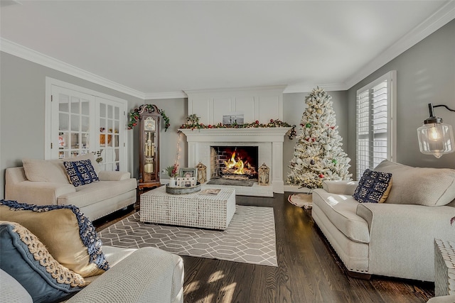 living room featuring french doors, a fireplace, ornamental molding, and dark hardwood / wood-style floors