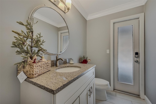 bathroom featuring ornamental molding, vanity, tile patterned floors, and toilet