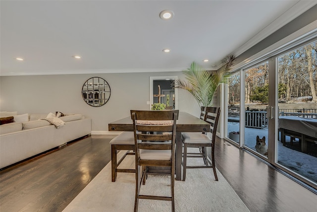 dining area with ornamental molding and hardwood / wood-style floors