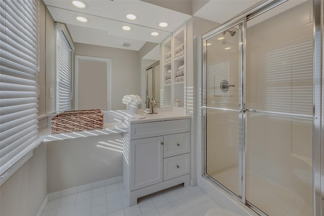 bathroom featuring walk in shower, vanity, and tile patterned flooring