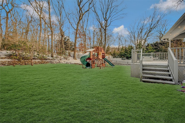 view of yard with a playground and a deck