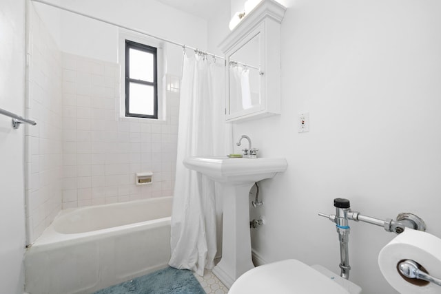 bathroom with shower / bath combination with curtain and toilet