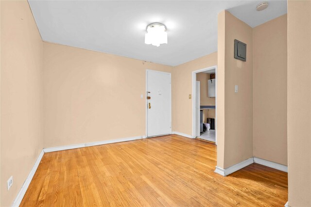 empty room with light hardwood / wood-style flooring