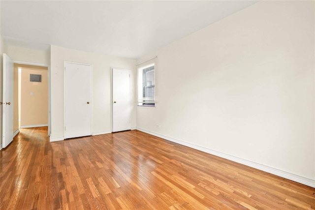 unfurnished bedroom featuring hardwood / wood-style flooring