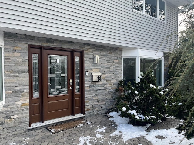 view of snow covered property entrance