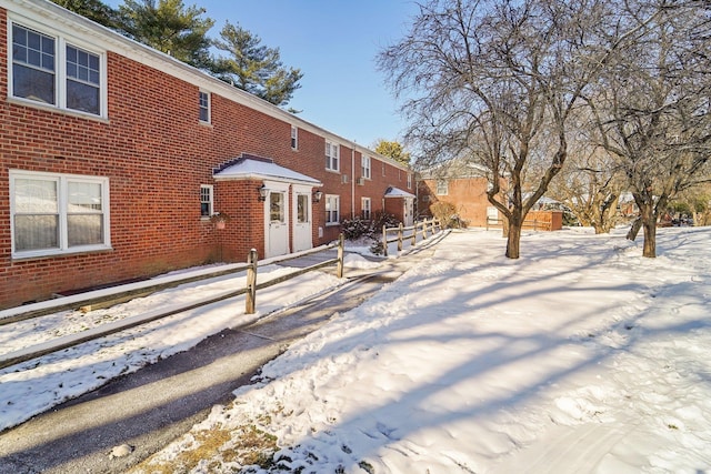 view of snow covered rear of property