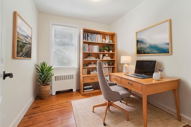 home office featuring radiator and light hardwood / wood-style floors