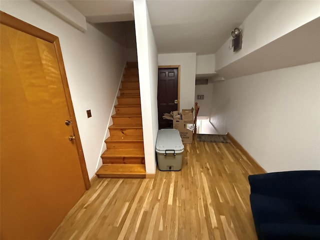 stairs with hardwood / wood-style flooring