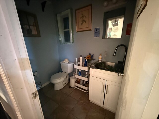 bathroom featuring vanity, tile patterned floors, and toilet