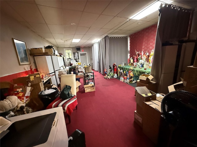 misc room featuring carpet flooring and a paneled ceiling