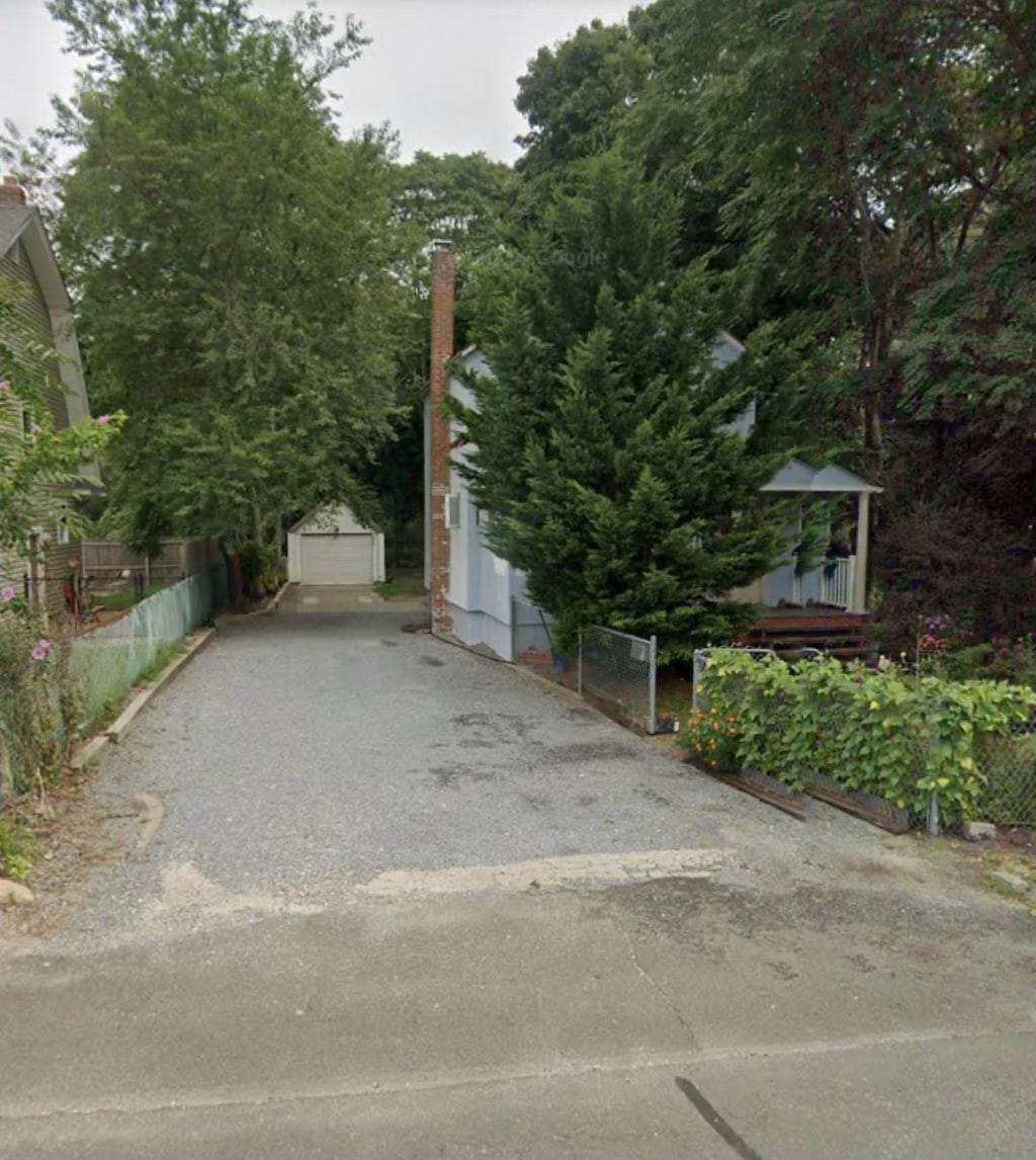 view of side of home featuring an outbuilding and a garage