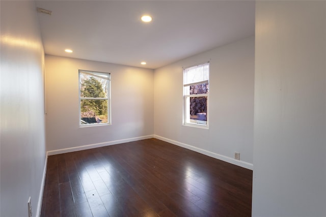 unfurnished room with baseboards, recessed lighting, and a healthy amount of sunlight