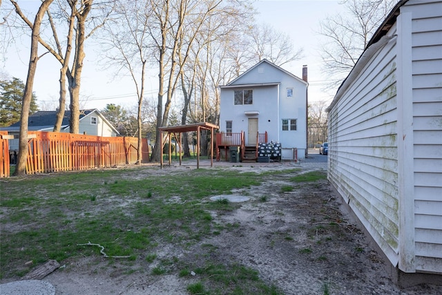 back of property featuring fence