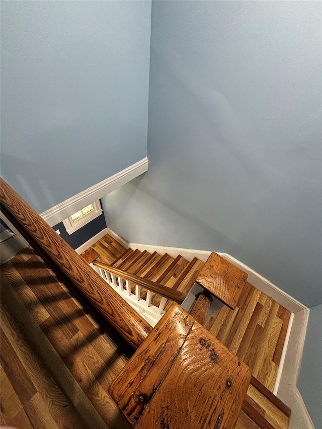 stairway featuring wood-type flooring