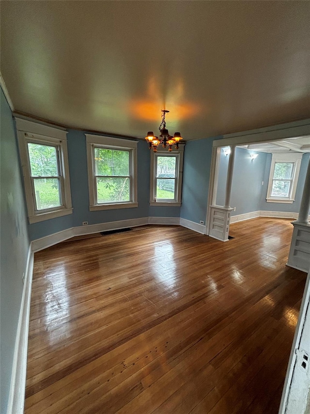 interior space with a notable chandelier and hardwood / wood-style flooring