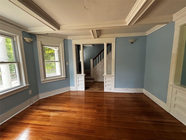 unfurnished room featuring hardwood / wood-style flooring, ornamental molding, and beamed ceiling