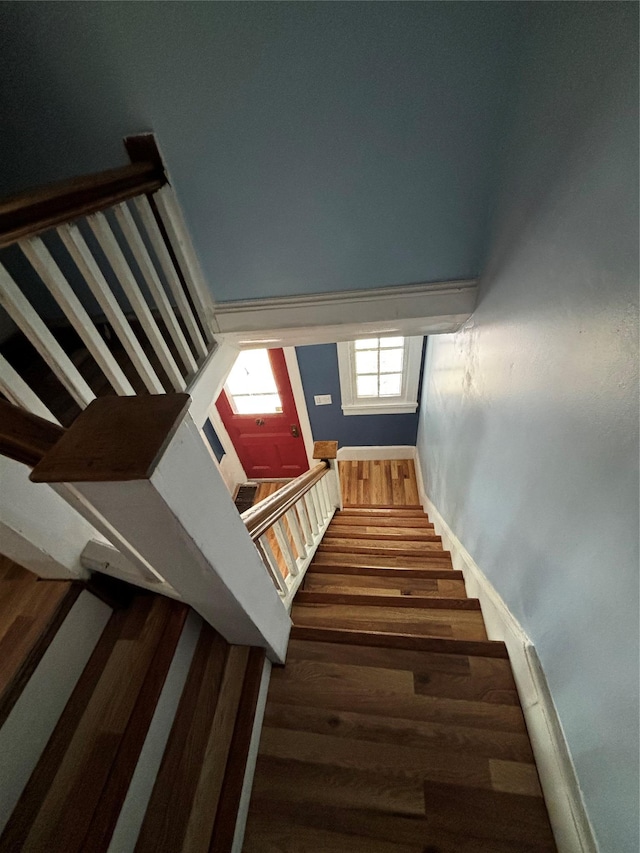 stairs featuring hardwood / wood-style floors