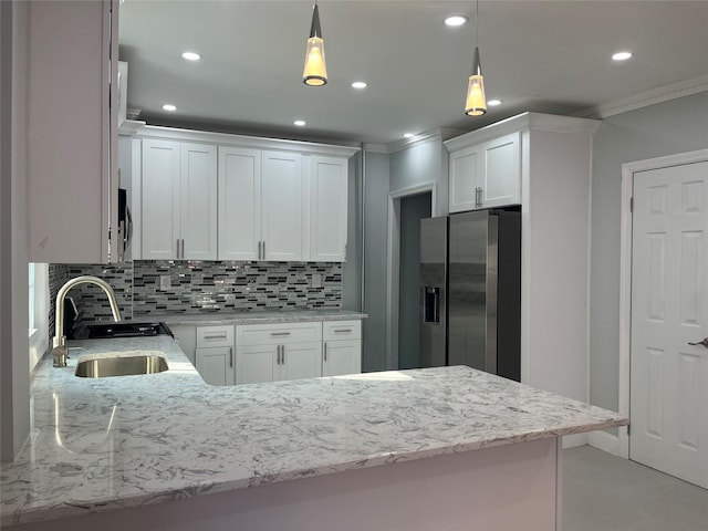 kitchen featuring hanging light fixtures, white cabinetry, sink, and stainless steel fridge with ice dispenser