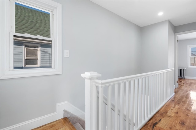 hall with radiator heating unit and light hardwood / wood-style floors