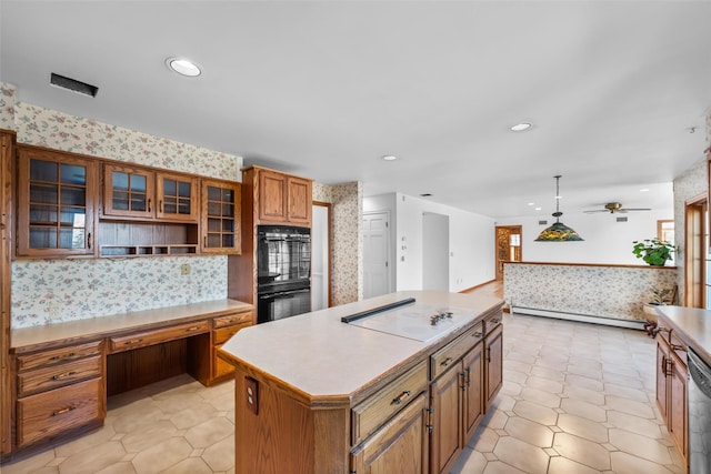 kitchen with brown cabinets, white electric cooktop, dobule oven black, and wallpapered walls