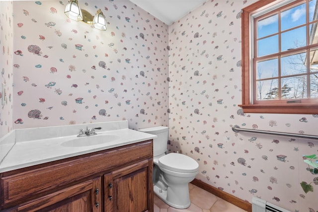 bathroom with toilet, wallpapered walls, a baseboard radiator, and tile patterned floors