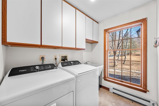 washroom with washer and clothes dryer, cabinet space, a baseboard heating unit, light tile patterned flooring, and baseboards