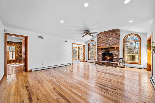 unfurnished living room featuring lofted ceiling, light wood-style floors, a baseboard radiator, and visible vents