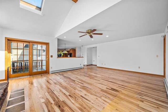 unfurnished living room with a baseboard heating unit, vaulted ceiling with skylight, light wood-style flooring, and recessed lighting