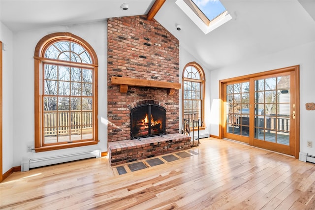 living area with a healthy amount of sunlight, a brick fireplace, baseboard heating, and wood finished floors