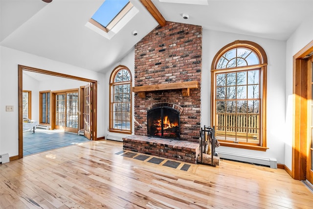 living room with hardwood / wood-style flooring, a baseboard heating unit, a fireplace, a skylight, and beam ceiling