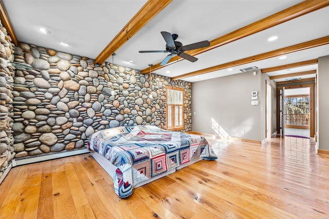 bedroom with baseboards, visible vents, a baseboard radiator, wood finished floors, and beamed ceiling