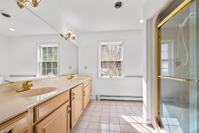 full bath with a wealth of natural light, a baseboard heating unit, and a sink