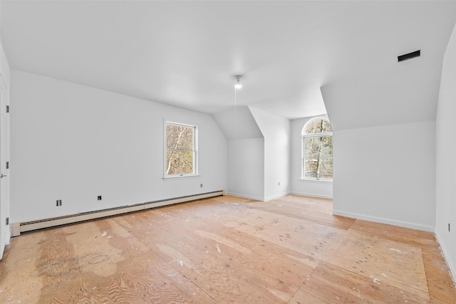 bonus room featuring lofted ceiling, baseboards, and baseboard heating