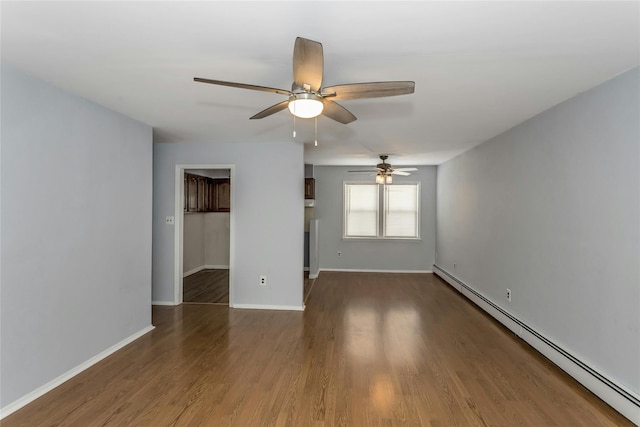 unfurnished room with dark hardwood / wood-style flooring and a baseboard radiator