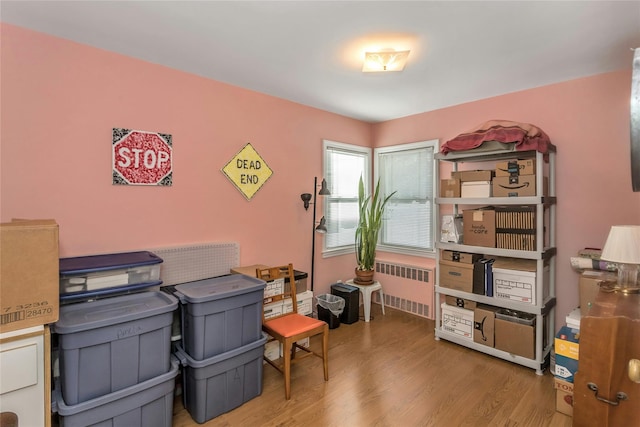 home office featuring radiator and hardwood / wood-style flooring