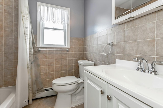 full bathroom with a baseboard radiator, tile walls, vanity, toilet, and tile patterned floors