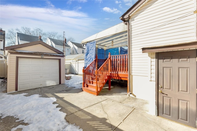 view of patio / terrace with a garage and an outdoor structure