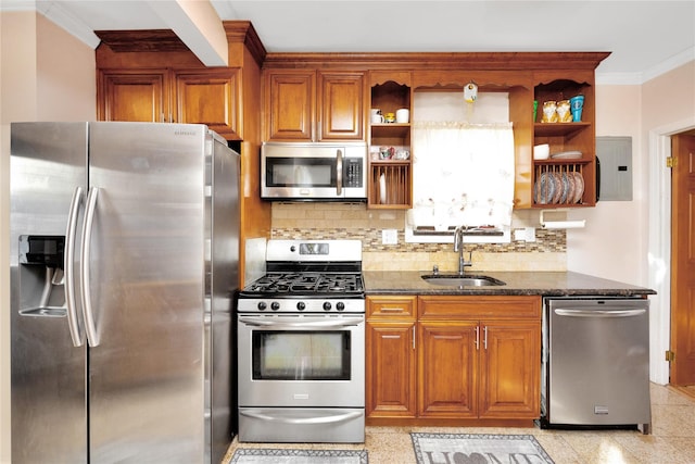 kitchen with sink, crown molding, appliances with stainless steel finishes, tasteful backsplash, and dark stone counters