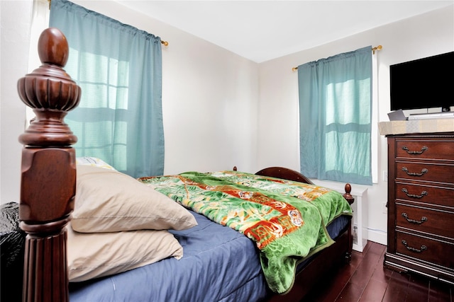 bedroom with dark wood-type flooring