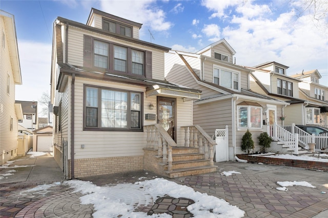 townhome / multi-family property featuring a garage and an outdoor structure