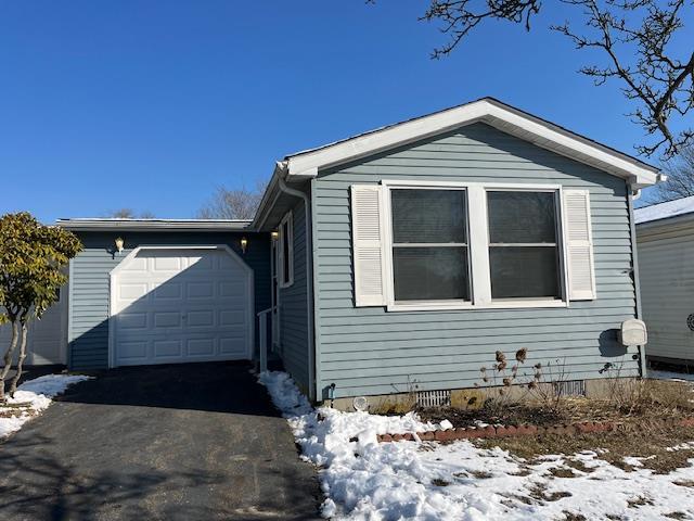 view of snow covered exterior featuring a garage