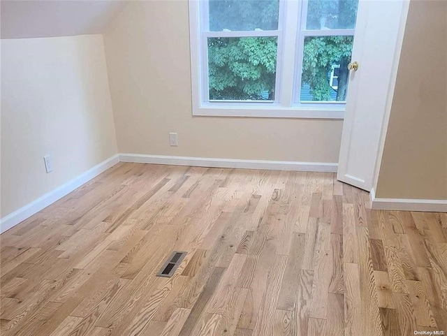 bonus room with light wood-type flooring