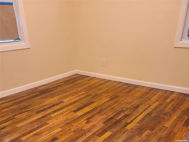 unfurnished room featuring hardwood / wood-style flooring