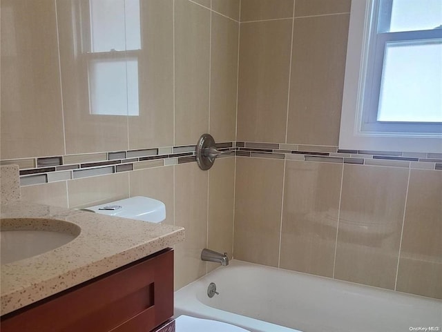 bathroom featuring vanity, toilet, and backsplash