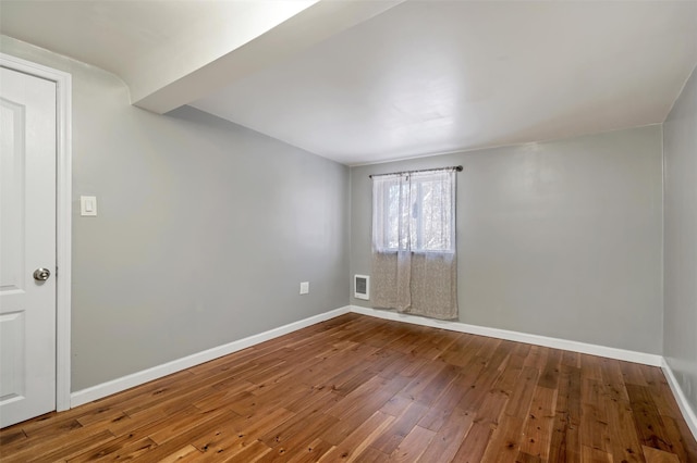 unfurnished room featuring hardwood / wood-style floors